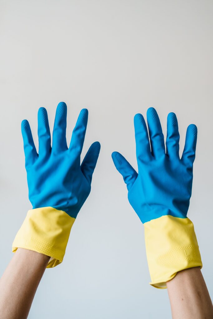 Manos con guantes de goma, la protección mínima para trabajar en un desagüe